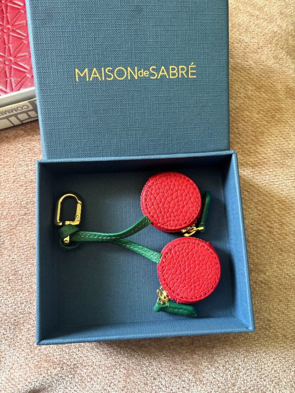 The SABRÉMOJI™ Fruit Charm  Special Edition AirTag Charm